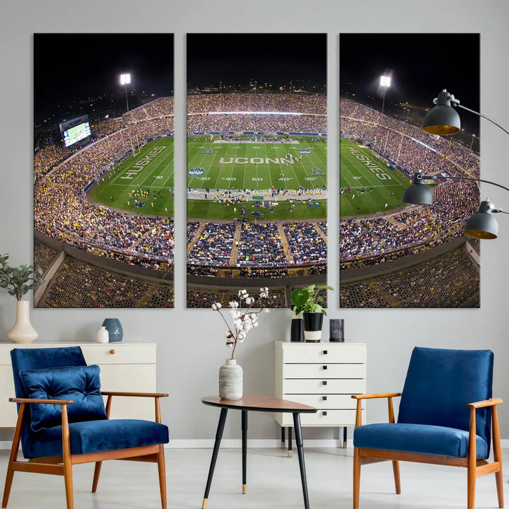 A triptych canvas artwork titled "The University of Connecticut UCONN Huskies Football Team Print" showcases a packed Pratt & Whitney Stadium in East Hartford at night, with a stunning gallery-quality finish.