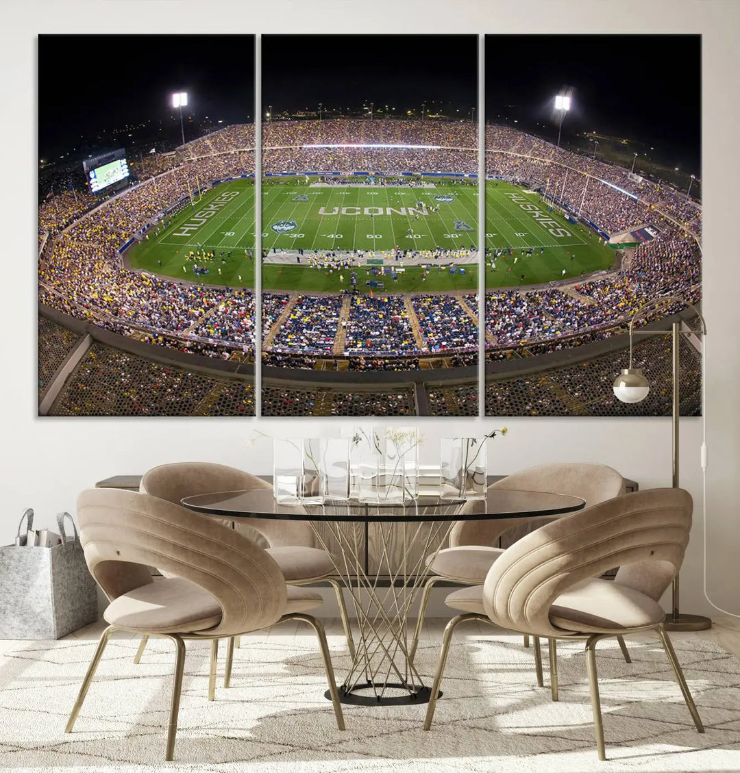 A triptych canvas artwork titled "The University of Connecticut UCONN Huskies Football Team Print" showcases a packed Pratt & Whitney Stadium in East Hartford at night, with a stunning gallery-quality finish.