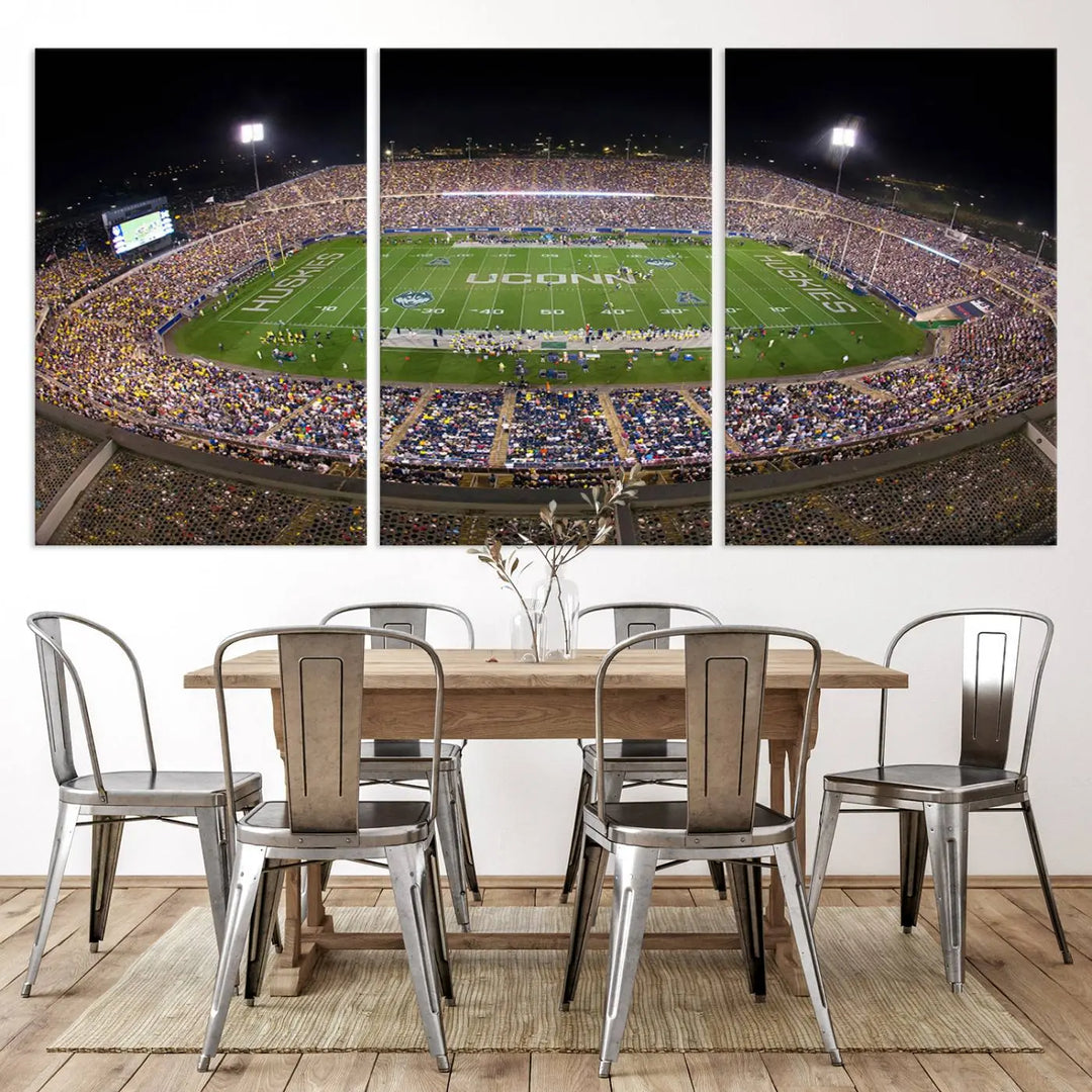 A triptych canvas artwork titled "The University of Connecticut UCONN Huskies Football Team Print" showcases a packed Pratt & Whitney Stadium in East Hartford at night, with a stunning gallery-quality finish.