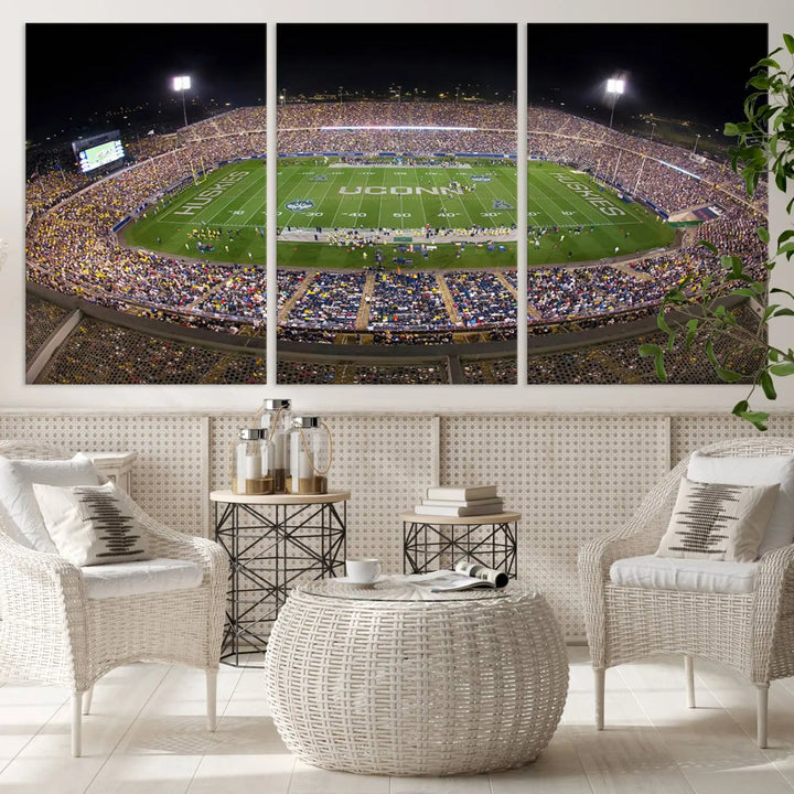 A triptych canvas artwork titled "The University of Connecticut UCONN Huskies Football Team Print" showcases a packed Pratt & Whitney Stadium in East Hartford at night, with a stunning gallery-quality finish.