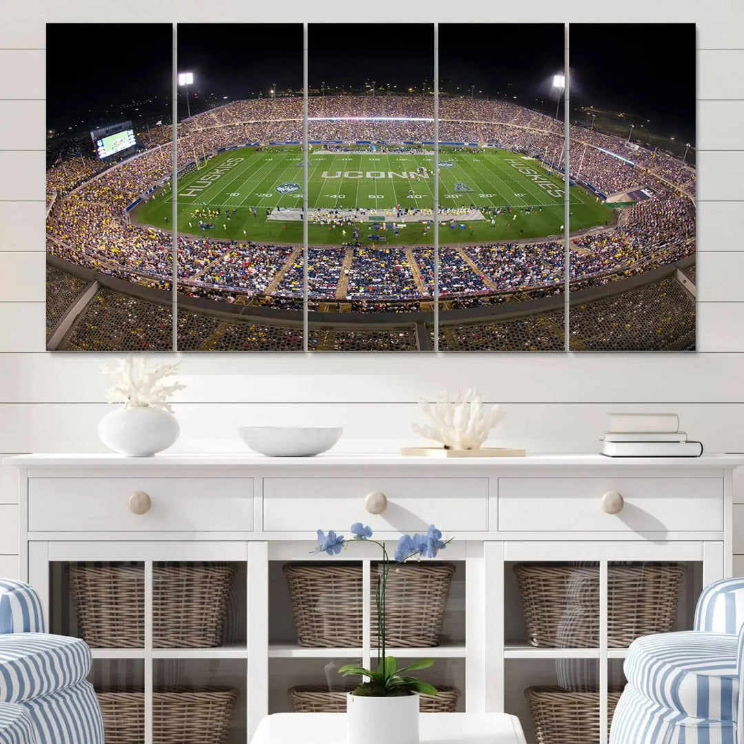 A triptych canvas artwork titled "The University of Connecticut UCONN Huskies Football Team Print" showcases a packed Pratt & Whitney Stadium in East Hartford at night, with a stunning gallery-quality finish.