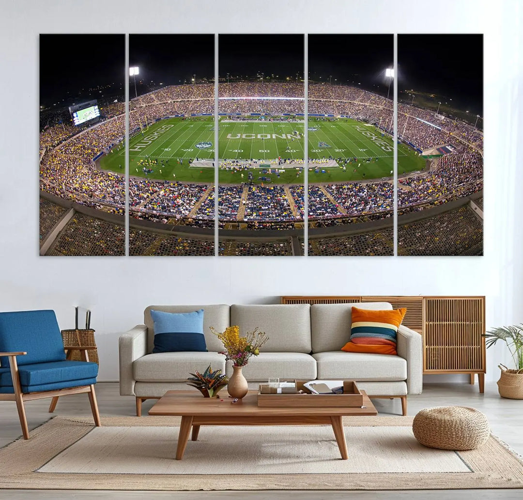 A triptych canvas artwork titled "The University of Connecticut UCONN Huskies Football Team Print" showcases a packed Pratt & Whitney Stadium in East Hartford at night, with a stunning gallery-quality finish.