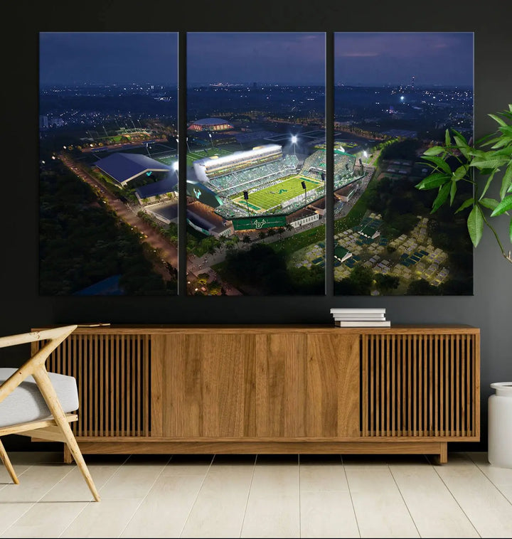 A living room showcasing 'The University of South Florida Bulls Football Team Print' as a triptych wall art highlights the Tampa USF Football Stadium under bright lights at night with a gallery-quality finish.