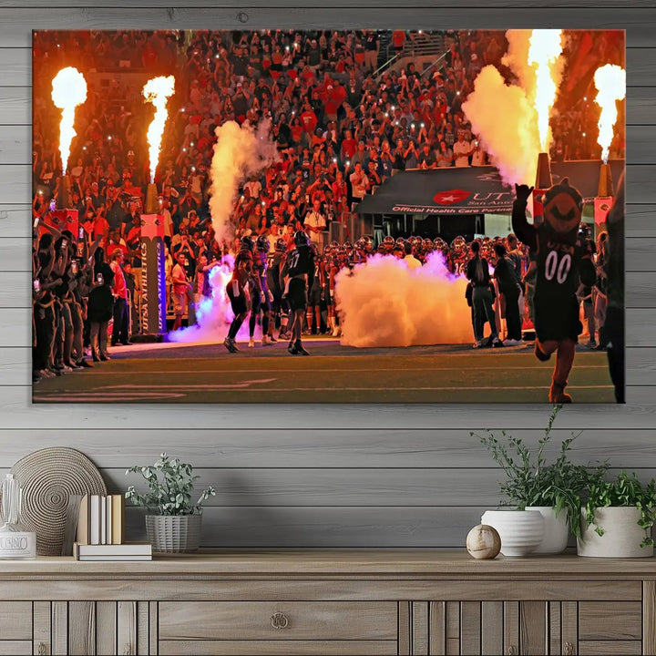 This museum-quality canvas, titled "The University of Texas at San Antonio Roadrunners Football Team Print - San Antonio Alamodome Wall Art Canvas Print," captures the intensity of a football game as players and a mascot charge through flames. The scene comes alive with high-resolution printing, crafted by professional artisans to bring a touch of excellence into your home.