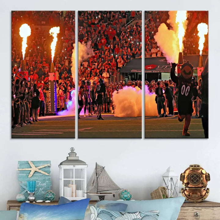 This museum-quality canvas, titled "The University of Texas at San Antonio Roadrunners Football Team Print - San Antonio Alamodome Wall Art Canvas Print," captures the intensity of a football game as players and a mascot charge through flames. The scene comes alive with high-resolution printing, crafted by professional artisans to bring a touch of excellence into your home.