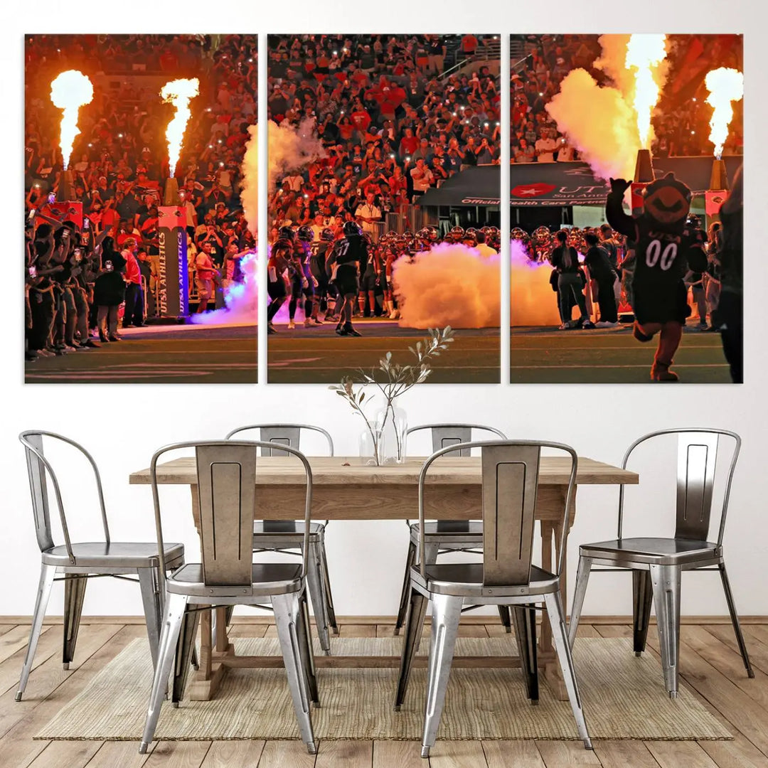 This museum-quality canvas, titled "The University of Texas at San Antonio Roadrunners Football Team Print - San Antonio Alamodome Wall Art Canvas Print," captures the intensity of a football game as players and a mascot charge through flames. The scene comes alive with high-resolution printing, crafted by professional artisans to bring a touch of excellence into your home.