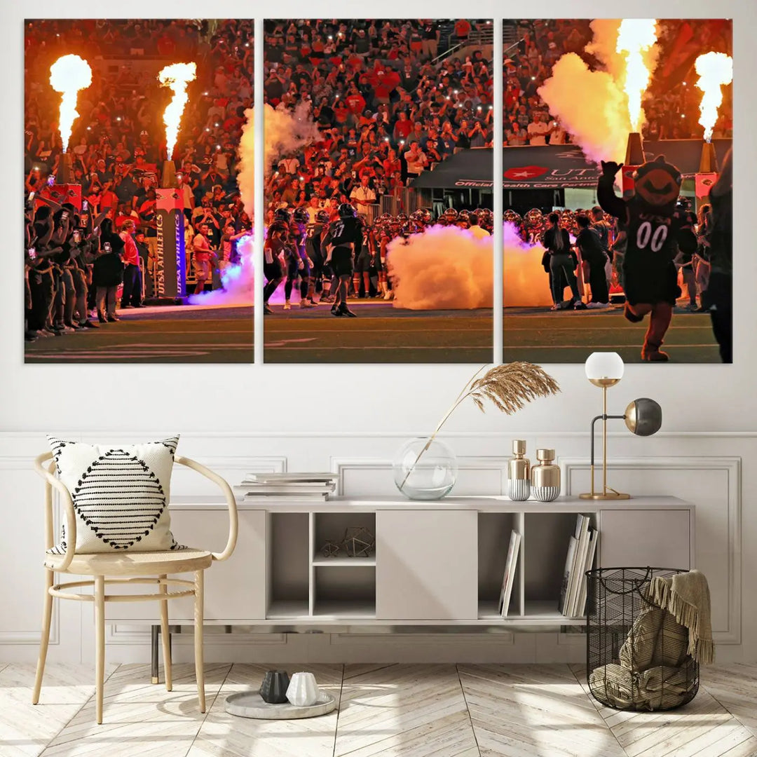 This museum-quality canvas, titled "The University of Texas at San Antonio Roadrunners Football Team Print - San Antonio Alamodome Wall Art Canvas Print," captures the intensity of a football game as players and a mascot charge through flames. The scene comes alive with high-resolution printing, crafted by professional artisans to bring a touch of excellence into your home.