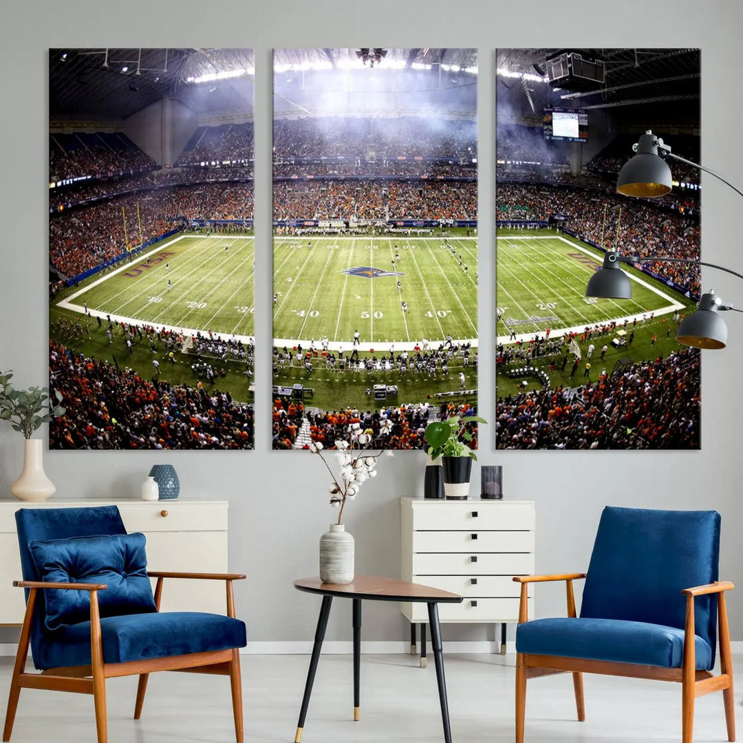 A living room features a striking piece of art on the wall, showcasing high-resolution printing on museum-quality canvas with "The University of Texas at San Antonio Roadrunners Football Team Print - San Antonio Alamodome Wall Art Canvas Print.