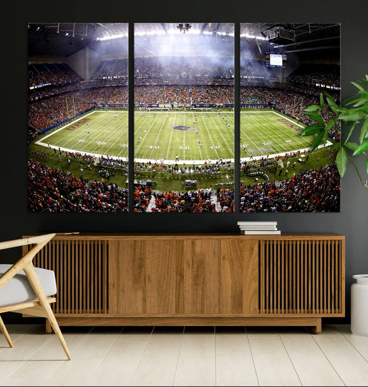 A living room features a striking piece of art on the wall, showcasing high-resolution printing on museum-quality canvas with "The University of Texas at San Antonio Roadrunners Football Team Print - San Antonio Alamodome Wall Art Canvas Print.