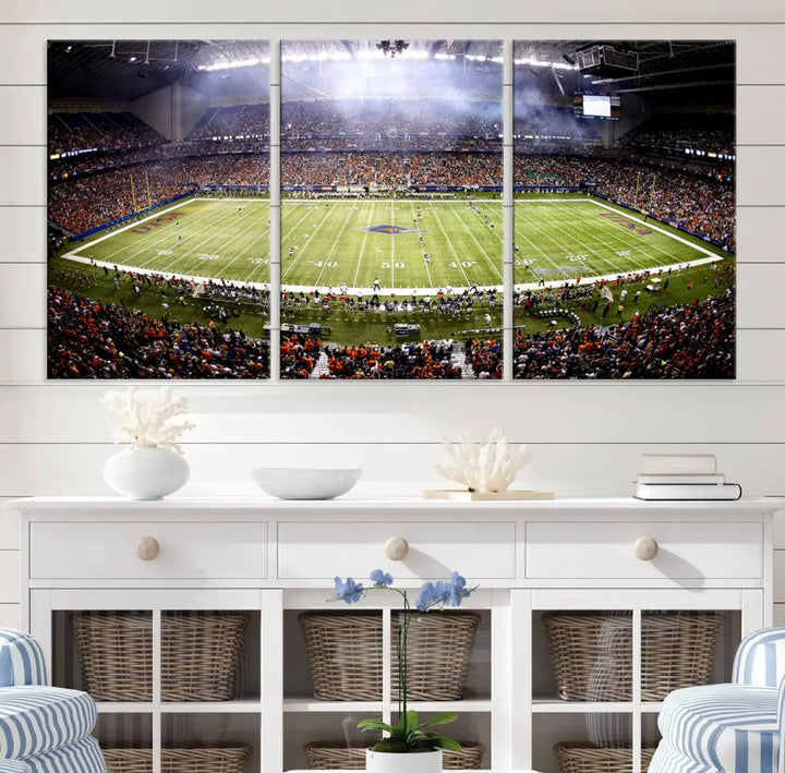 A living room features a striking piece of art on the wall, showcasing high-resolution printing on museum-quality canvas with "The University of Texas at San Antonio Roadrunners Football Team Print - San Antonio Alamodome Wall Art Canvas Print.