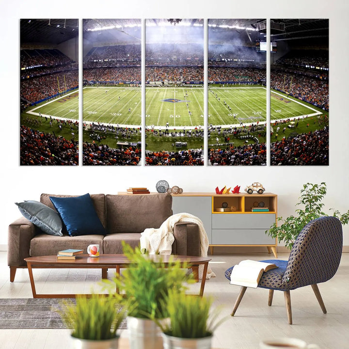 A living room features a striking piece of art on the wall, showcasing high-resolution printing on museum-quality canvas with "The University of Texas at San Antonio Roadrunners Football Team Print - San Antonio Alamodome Wall Art Canvas Print.