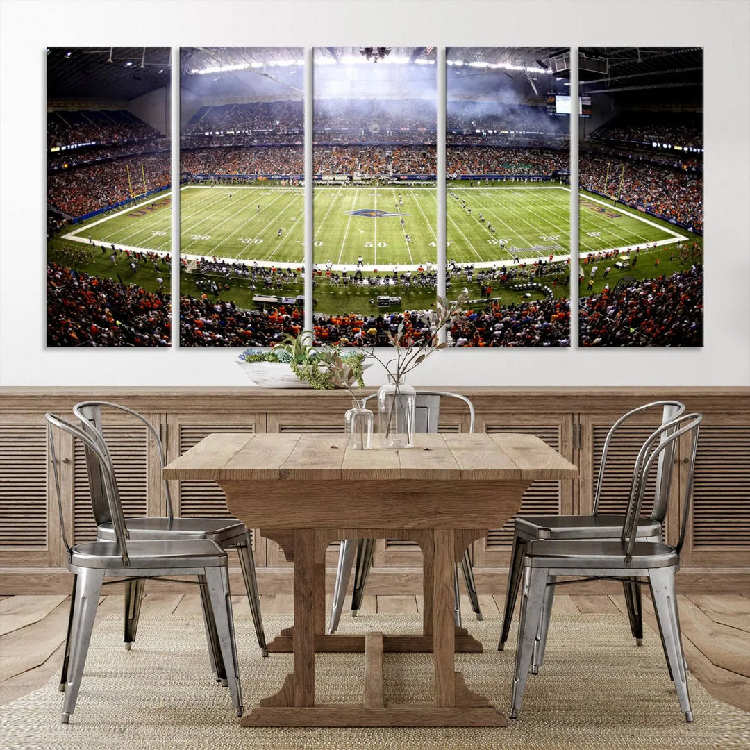 A living room features a striking piece of art on the wall, showcasing high-resolution printing on museum-quality canvas with "The University of Texas at San Antonio Roadrunners Football Team Print - San Antonio Alamodome Wall Art Canvas Print.