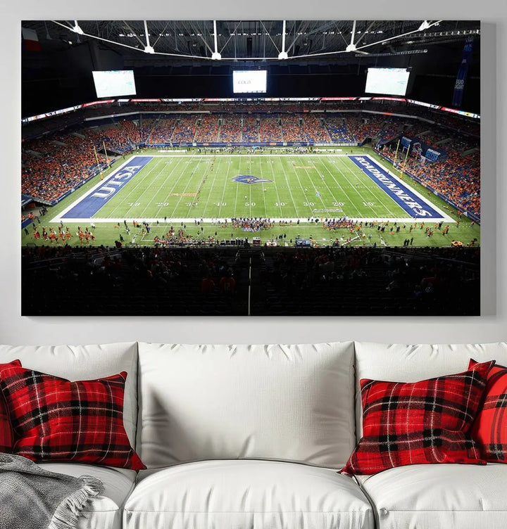 The living room features a large wall art of The University of Texas at San Antonio Roadrunners Football Team, capturing the vibrant atmosphere of the San Antonio Alamodome and printed with museum-quality precision.