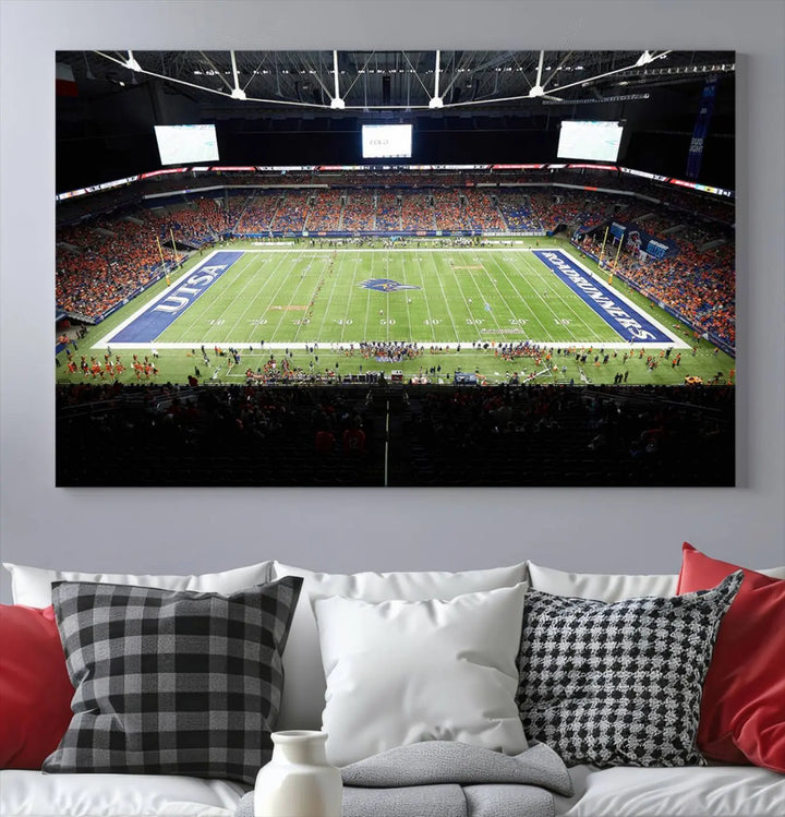 The living room features a large wall art of The University of Texas at San Antonio Roadrunners Football Team, capturing the vibrant atmosphere of the San Antonio Alamodome and printed with museum-quality precision.