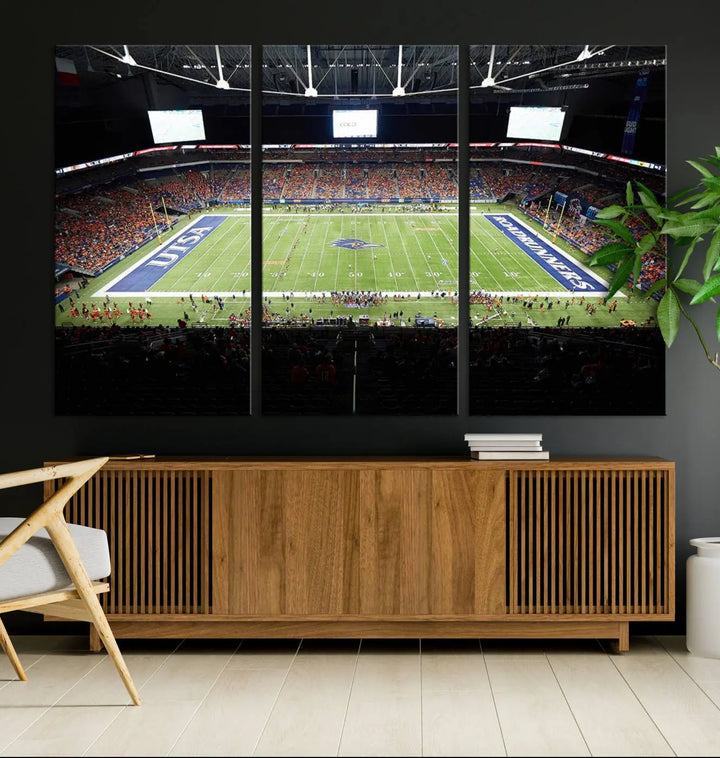 The living room features a large wall art of The University of Texas at San Antonio Roadrunners Football Team, capturing the vibrant atmosphere of the San Antonio Alamodome and printed with museum-quality precision.