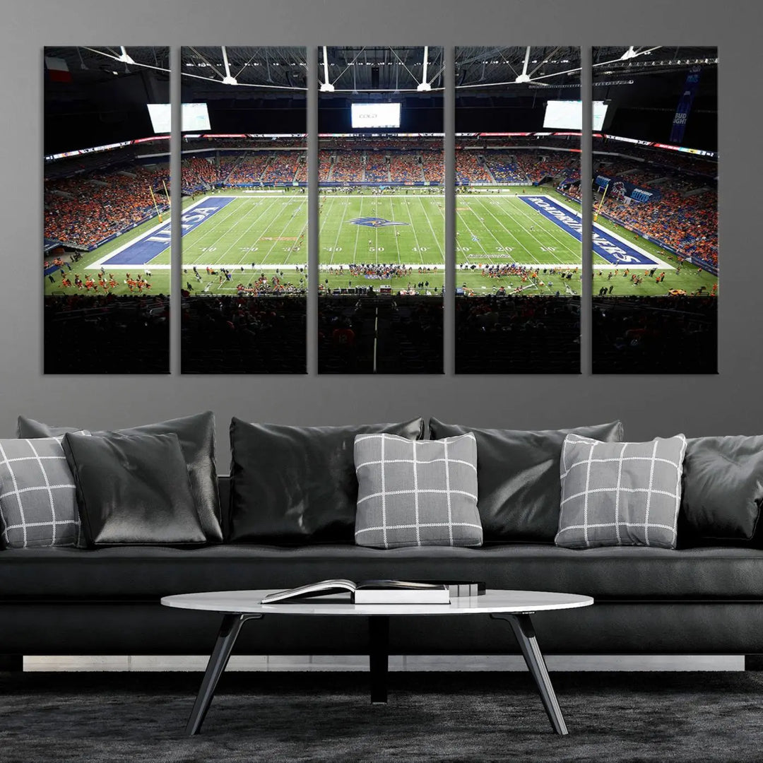 The living room features a large wall art of The University of Texas at San Antonio Roadrunners Football Team, capturing the vibrant atmosphere of the San Antonio Alamodome and printed with museum-quality precision.