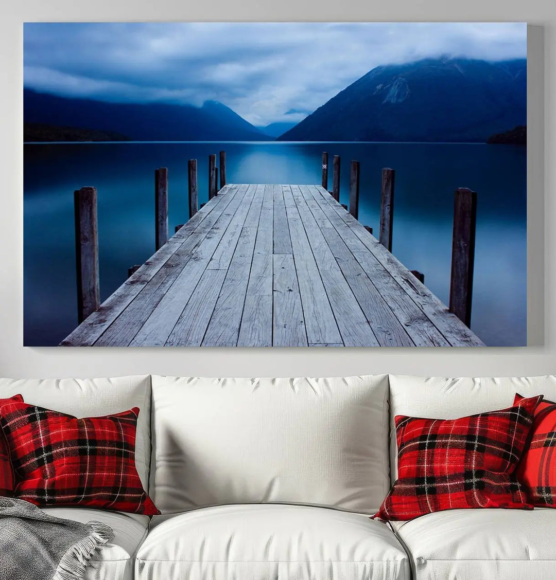 Tranquil lakeside pier triptych canvas art featuring a blue mountain horizon and serene dock. Perfect for modern interiors. High-quality giclee canvas print.