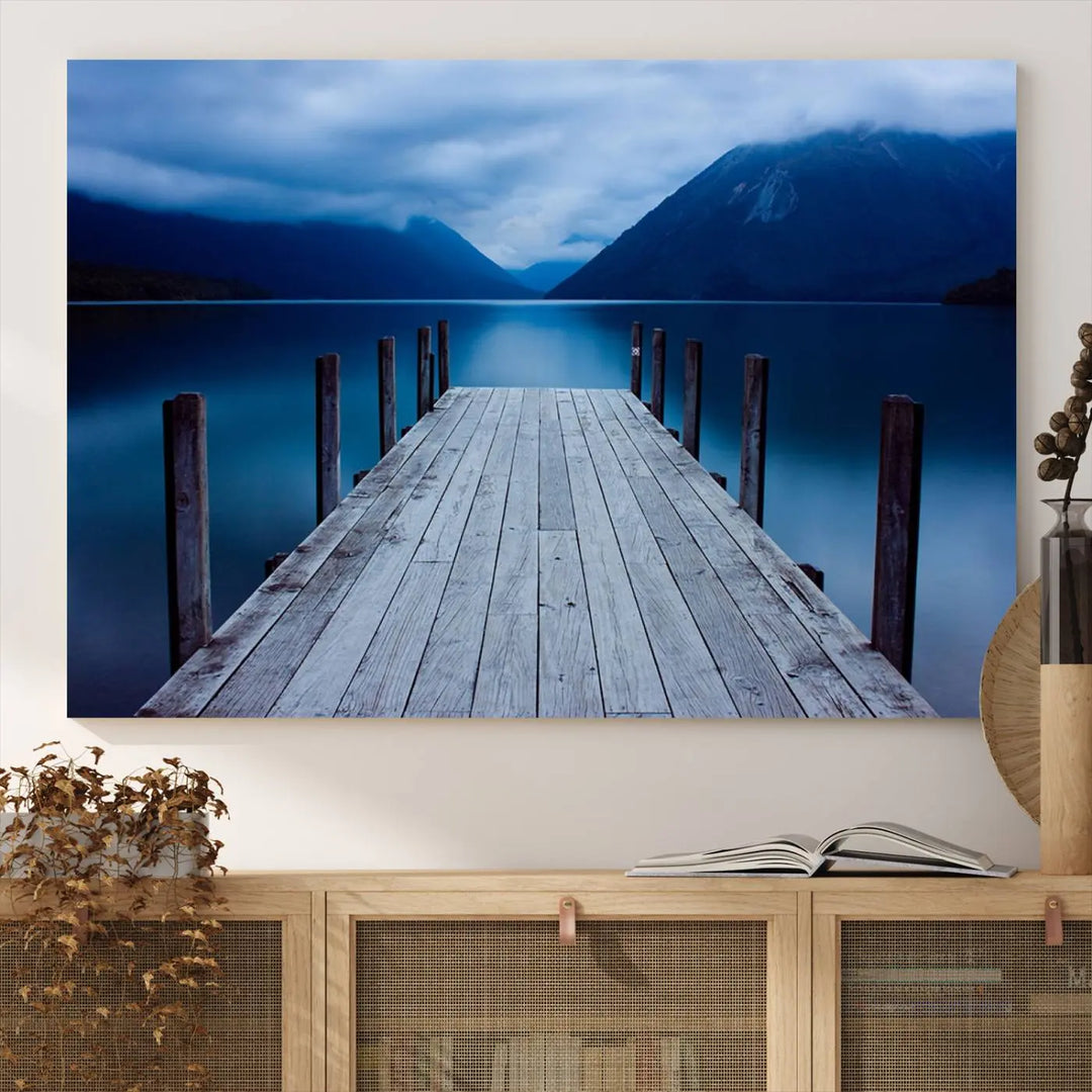 Tranquil lakeside pier triptych canvas art featuring a blue mountain horizon and serene dock. Perfect for modern interiors. High-quality giclee canvas print.