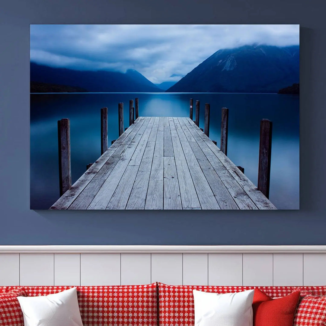 Tranquil lakeside pier triptych canvas art featuring a blue mountain horizon and serene dock. Perfect for modern interiors. High-quality giclee canvas print.