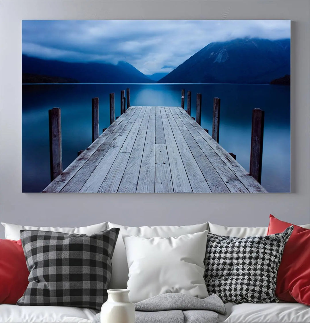 Tranquil lakeside pier triptych canvas art featuring a blue mountain horizon and serene dock. Perfect for modern interiors. High-quality giclee canvas print.