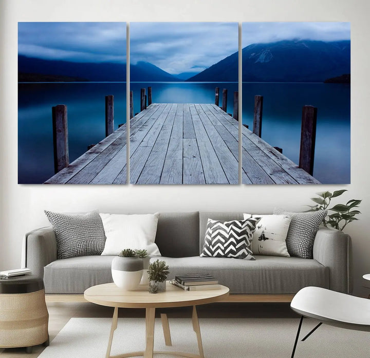 Tranquil lakeside pier triptych canvas art featuring a blue mountain horizon and serene dock. Perfect for modern interiors. High-quality giclee canvas print.