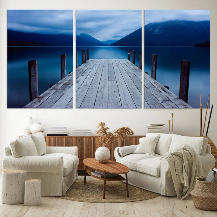 Tranquil lakeside pier triptych canvas art featuring a blue mountain horizon and serene dock. Perfect for modern interiors. High-quality giclee canvas print.