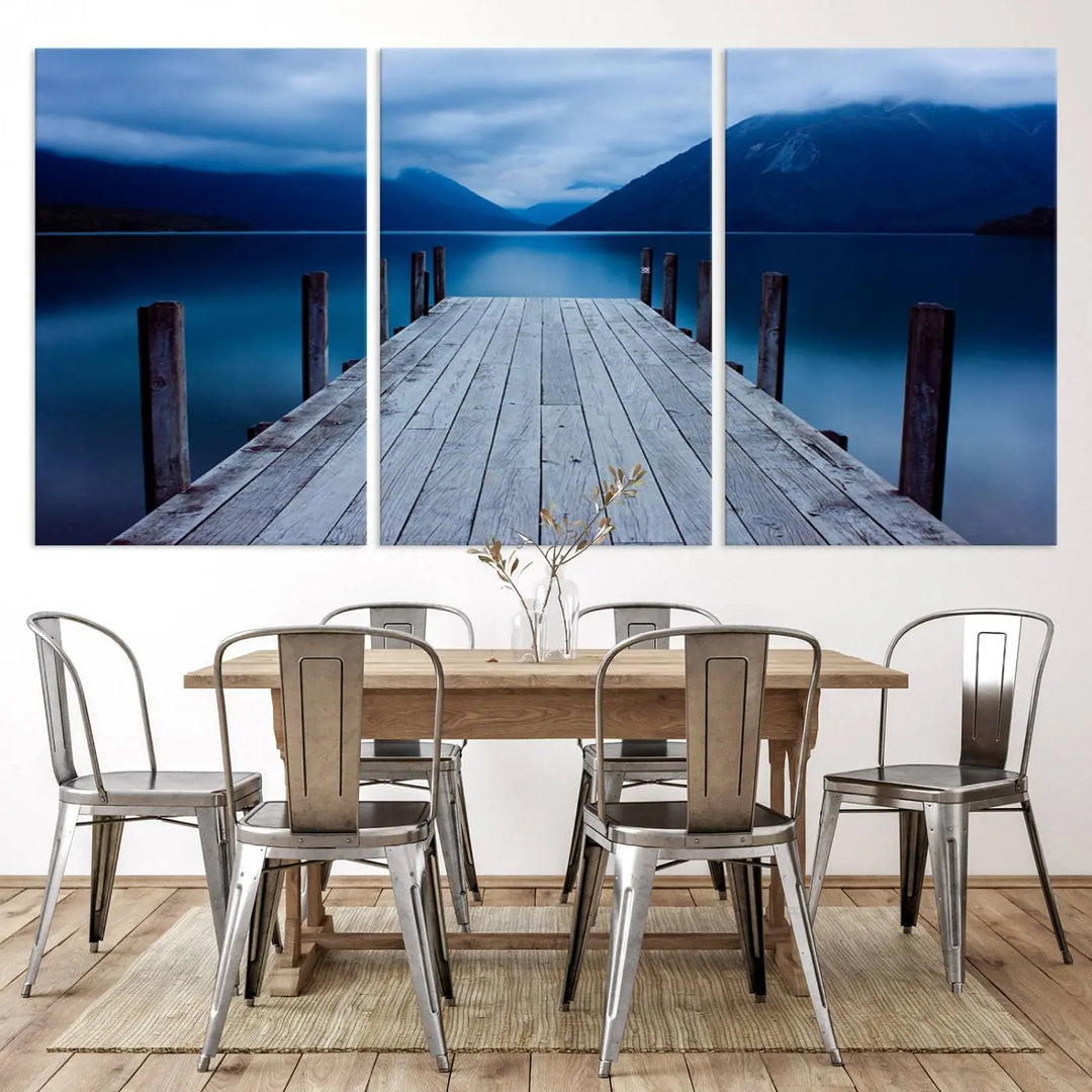 Tranquil lakeside pier triptych canvas art featuring a blue mountain horizon and serene dock. Perfect for modern interiors. High-quality giclee canvas print.