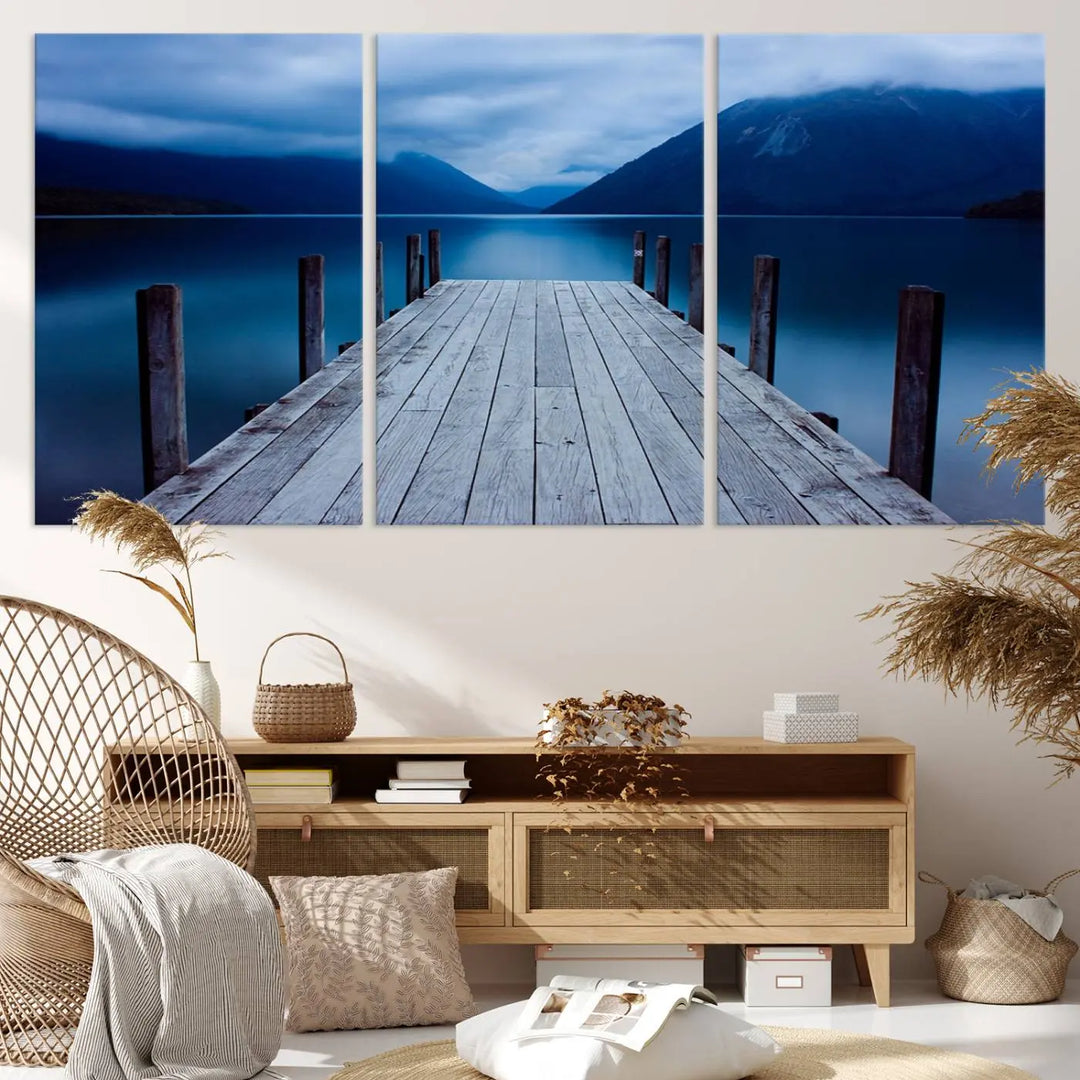 Tranquil lakeside pier triptych canvas art featuring a blue mountain horizon and serene dock. Perfect for modern interiors. High-quality giclee canvas print.