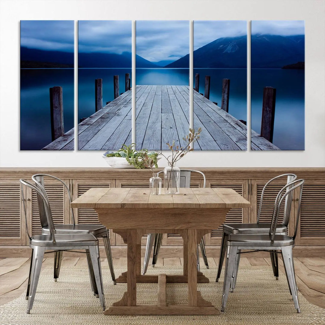 Tranquil lakeside pier triptych canvas art featuring a blue mountain horizon and serene dock. Perfect for modern interiors. High-quality giclee canvas print.