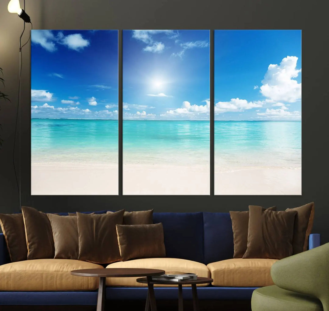 A serene living room is adorned with beach-themed artwork, featuring the Tranquil Ocean Paradise Triptych Wall Art that creates a soothing atmosphere. The neutral decor perfectly enhances the coastal retreat ambiance.