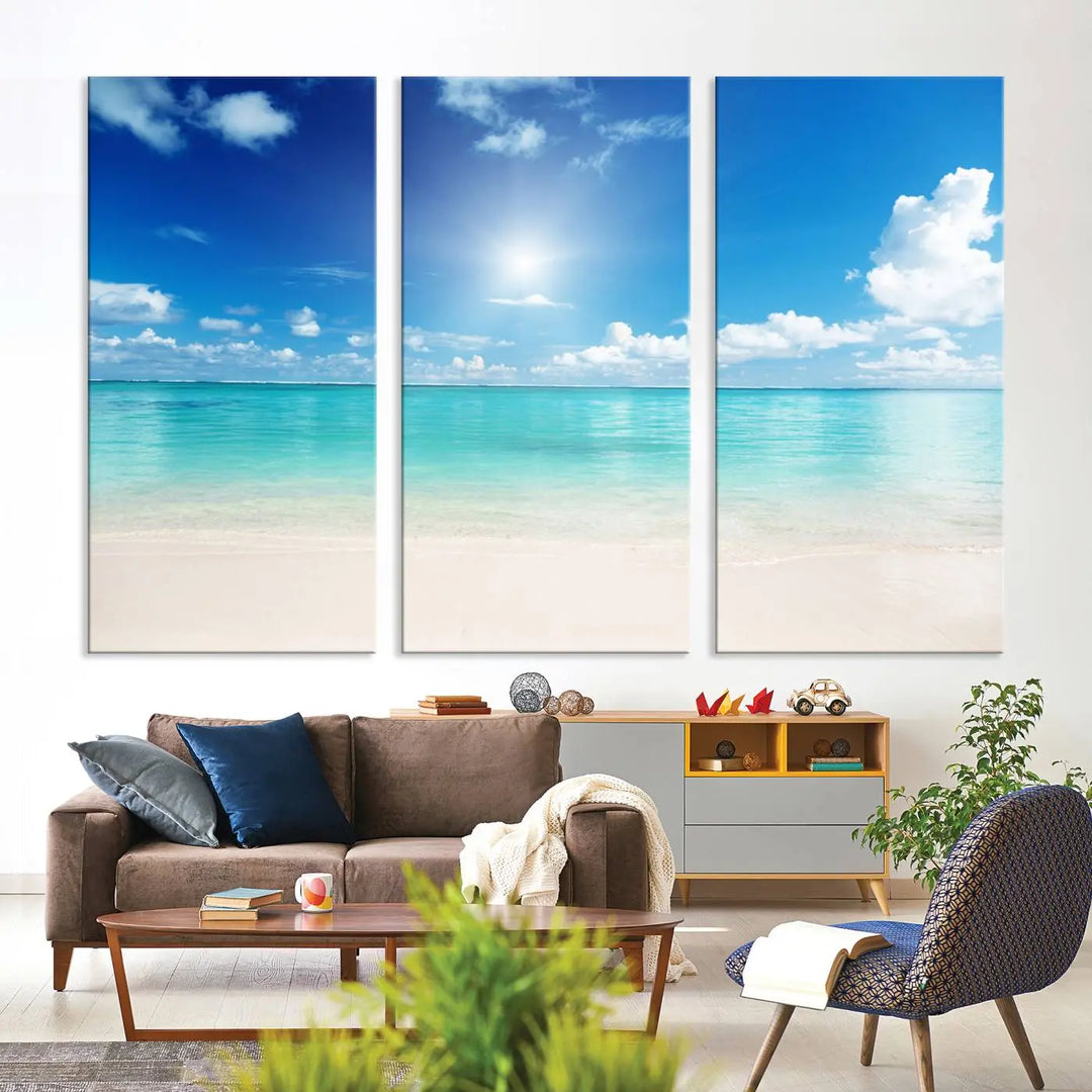 A serene living room is adorned with beach-themed artwork, featuring the Tranquil Ocean Paradise Triptych Wall Art that creates a soothing atmosphere. The neutral decor perfectly enhances the coastal retreat ambiance.