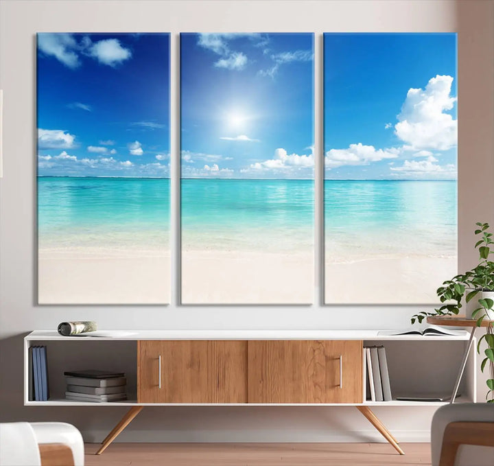 A serene living room is adorned with beach-themed artwork, featuring the Tranquil Ocean Paradise Triptych Wall Art that creates a soothing atmosphere. The neutral decor perfectly enhances the coastal retreat ambiance.