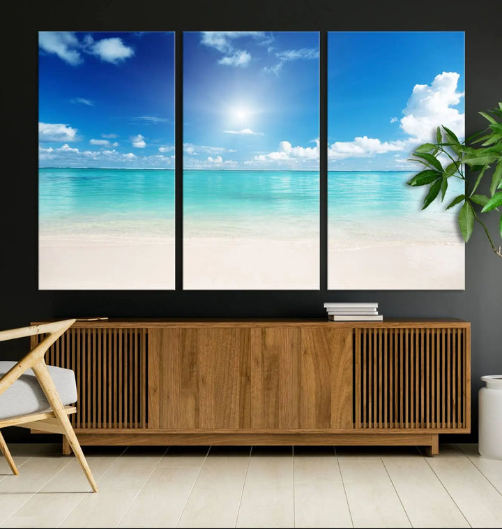 A serene living room is adorned with beach-themed artwork, featuring the Tranquil Ocean Paradise Triptych Wall Art that creates a soothing atmosphere. The neutral decor perfectly enhances the coastal retreat ambiance.