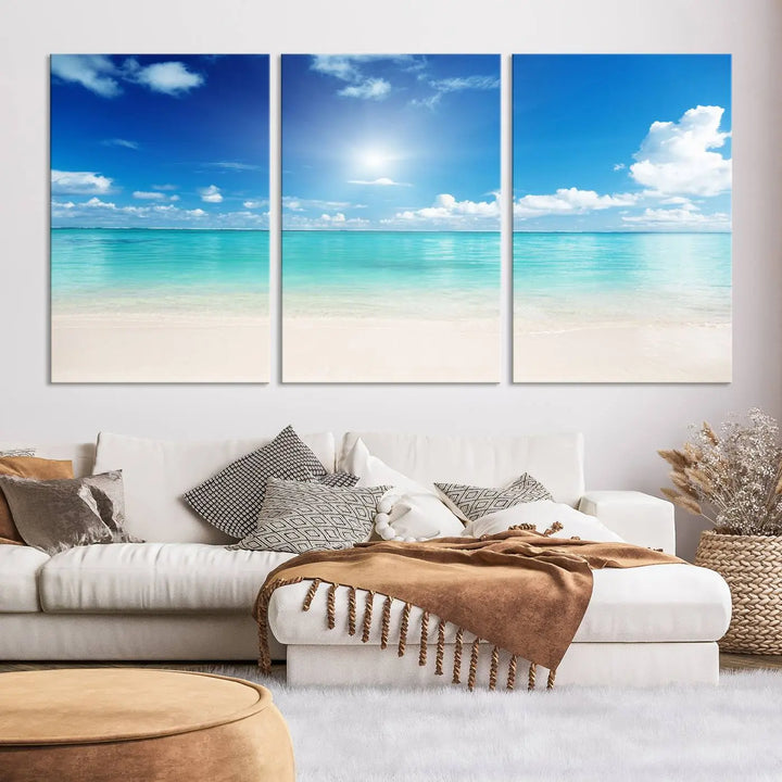 A serene living room is adorned with beach-themed artwork, featuring the Tranquil Ocean Paradise Triptych Wall Art that creates a soothing atmosphere. The neutral decor perfectly enhances the coastal retreat ambiance.