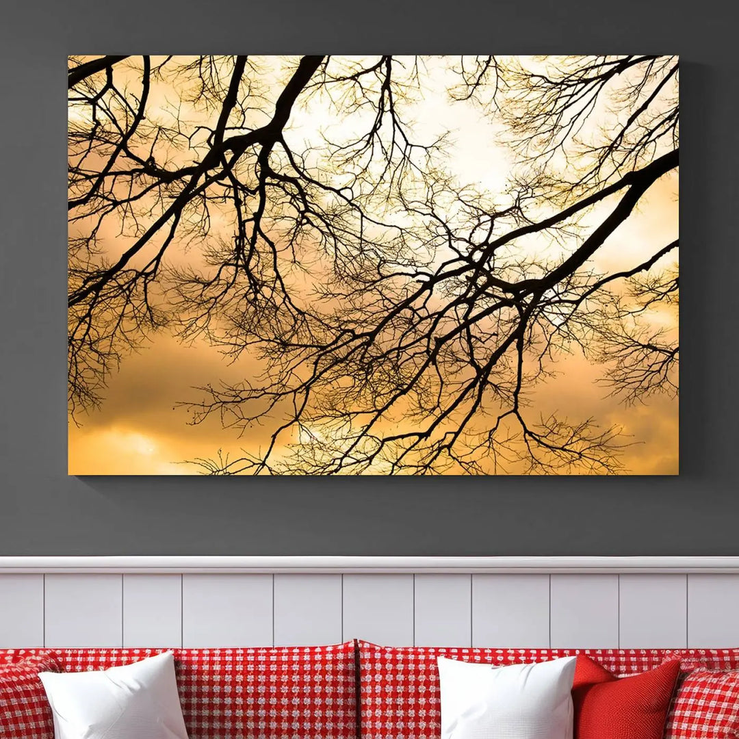 The Tree Branch Wall Art Canvas Print is a triptych depicting tree branches against an orange sky, printed on museum-quality canvases. Each piece comes ready to hang, offering both style and convenience.