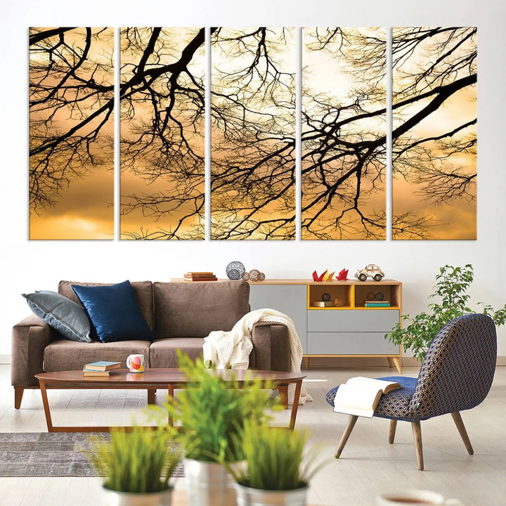 The Tree Branch Wall Art Canvas Print is a triptych depicting tree branches against an orange sky, printed on museum-quality canvases. Each piece comes ready to hang, offering both style and convenience.