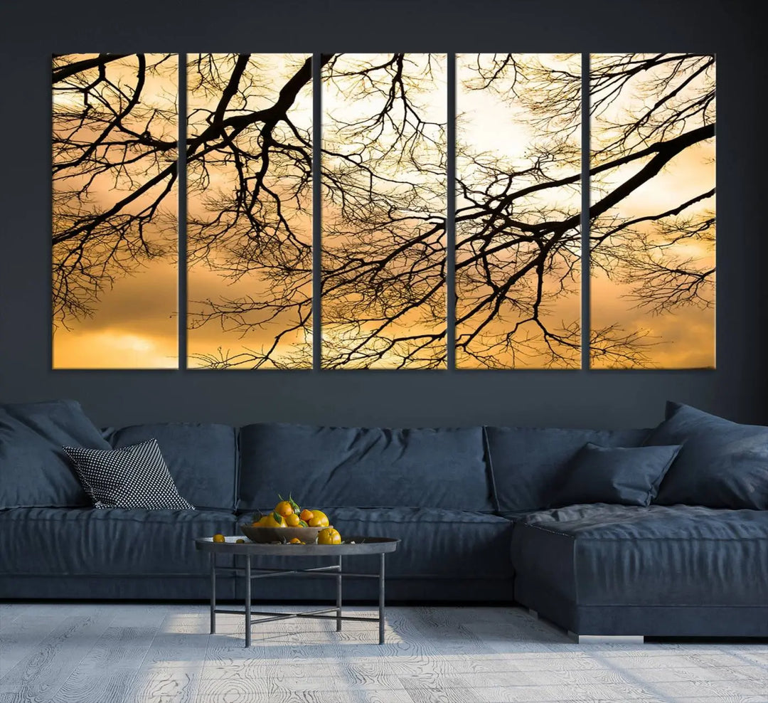 The Tree Branch Wall Art Canvas Print is a triptych depicting tree branches against an orange sky, printed on museum-quality canvases. Each piece comes ready to hang, offering both style and convenience.