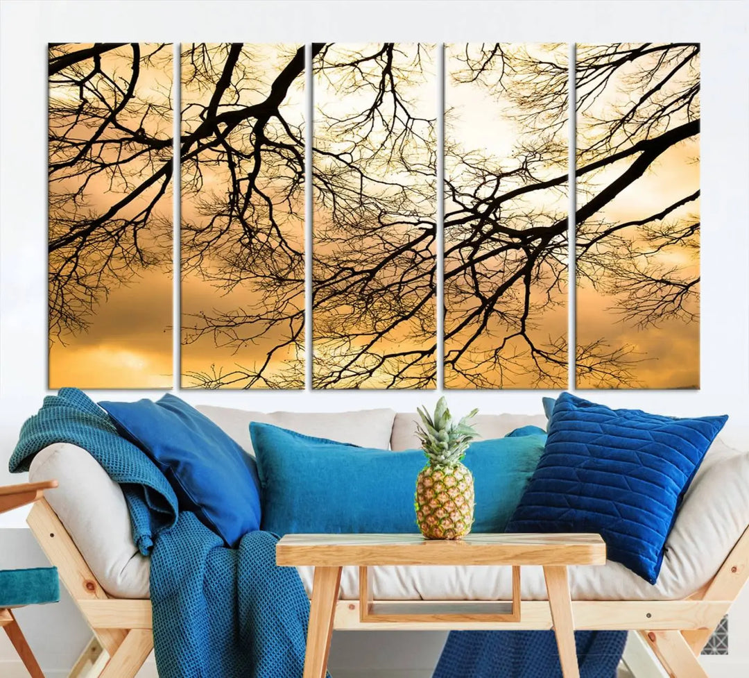 The Tree Branch Wall Art Canvas Print is a triptych depicting tree branches against an orange sky, printed on museum-quality canvases. Each piece comes ready to hang, offering both style and convenience.