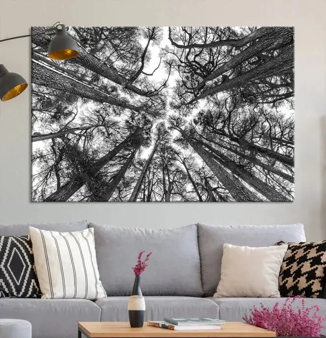 The "Trees Contemporary Art Canvas Print" is a striking black and white triptych featuring tall trees viewed from below. This artwork is gallery wrapped on museum-quality canvas, complete with a UV-protective coating to ensure its longevity.