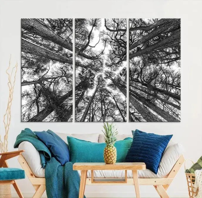 The "Trees Contemporary Art Canvas Print" is a striking black and white triptych featuring tall trees viewed from below. This artwork is gallery wrapped on museum-quality canvas, complete with a UV-protective coating to ensure its longevity.