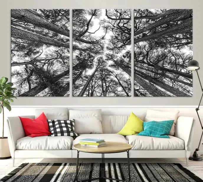 The "Trees Contemporary Art Canvas Print" is a striking black and white triptych featuring tall trees viewed from below. This artwork is gallery wrapped on museum-quality canvas, complete with a UV-protective coating to ensure its longevity.