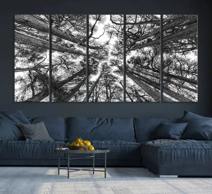 The "Trees Contemporary Art Canvas Print" is a striking black and white triptych featuring tall trees viewed from below. This artwork is gallery wrapped on museum-quality canvas, complete with a UV-protective coating to ensure its longevity.