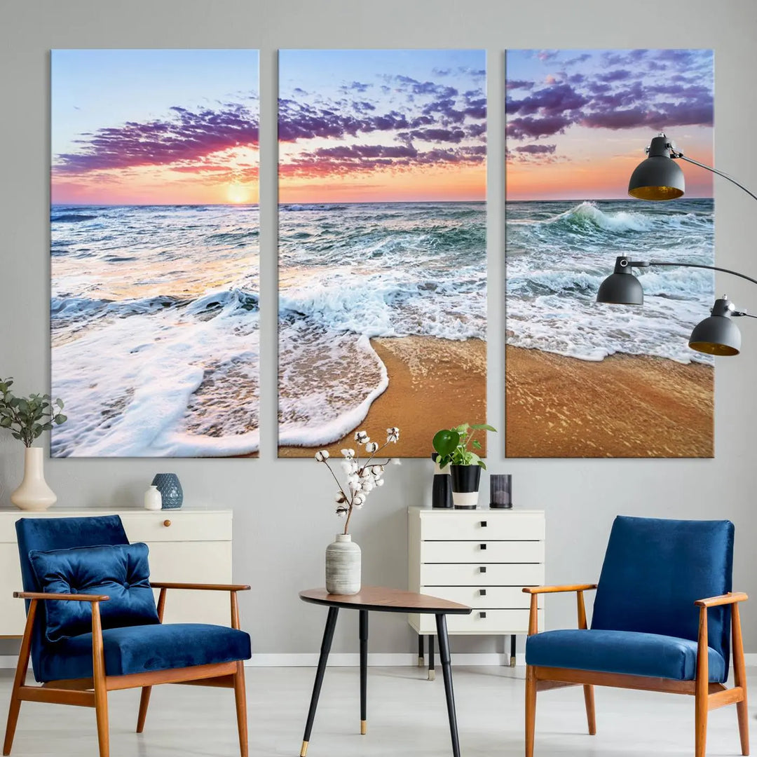 A triptych canvas wall art featuring the Tropical Beach Waves Art Print with a sunset ocean seascape adds striking beauty and perfectly complements the modern living room’s coastal decor.