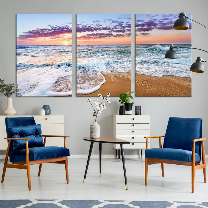 A triptych canvas wall art featuring the Tropical Beach Waves Art Print with a sunset ocean seascape adds striking beauty and perfectly complements the modern living room’s coastal decor.