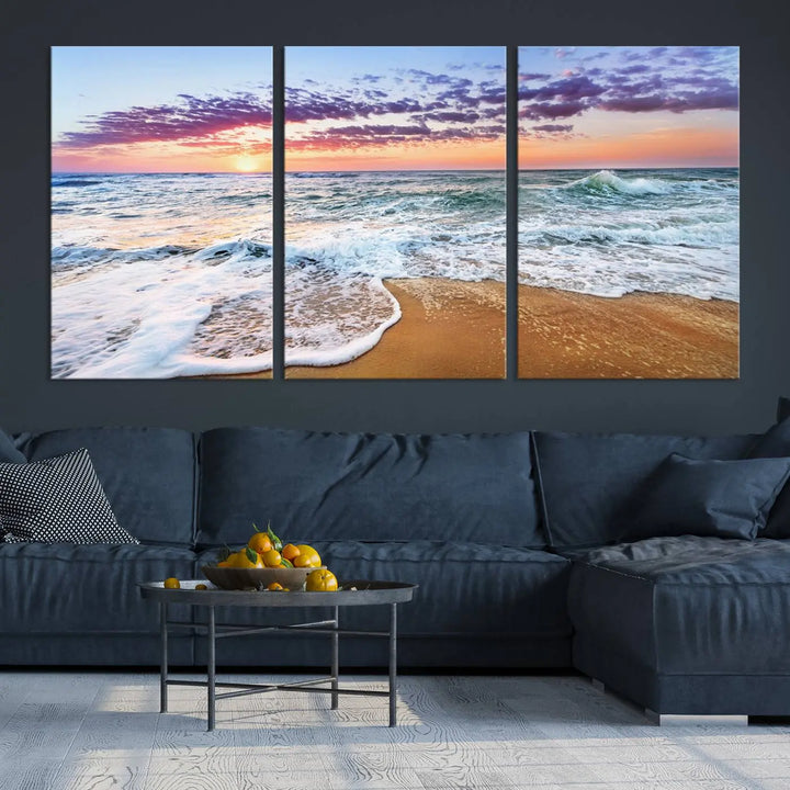 A triptych canvas wall art featuring the Tropical Beach Waves Art Print with a sunset ocean seascape adds striking beauty and perfectly complements the modern living room’s coastal decor.