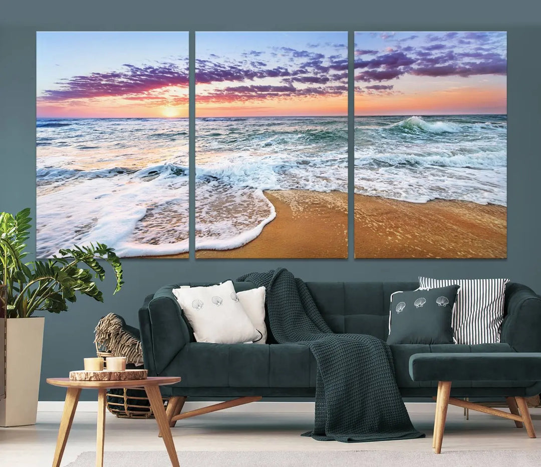 A triptych canvas wall art featuring the Tropical Beach Waves Art Print with a sunset ocean seascape adds striking beauty and perfectly complements the modern living room’s coastal decor.