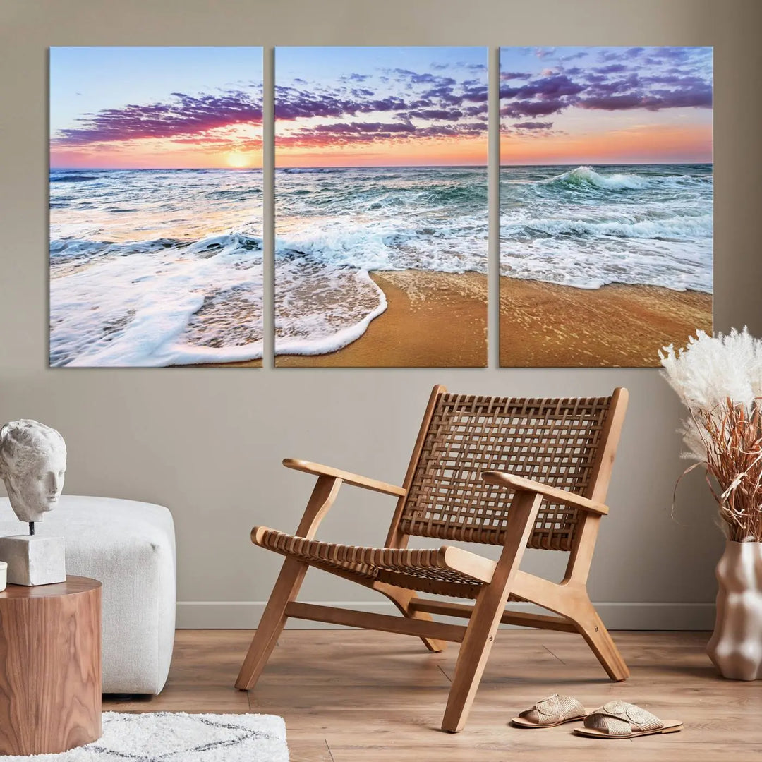 A triptych canvas wall art featuring the Tropical Beach Waves Art Print with a sunset ocean seascape adds striking beauty and perfectly complements the modern living room’s coastal decor.