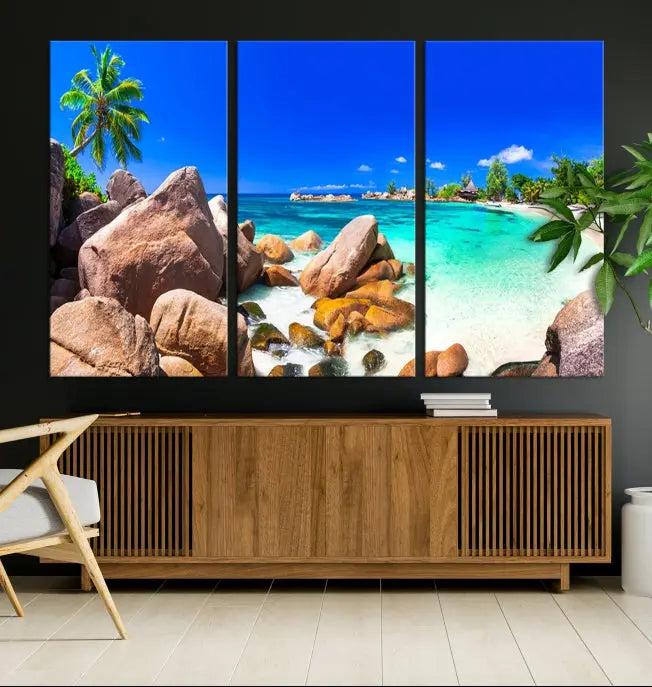 Experience a vibrant escape with the Tropical Beach and Island Wall Art Canvas Print, featuring a triptych of a tropical beach scene complete with rocks, palm trees, and turquoise water. Crafted on museum-quality canvases for an exquisite touch, each piece is gallery wrapped to ensure seamless display and lasting beauty.