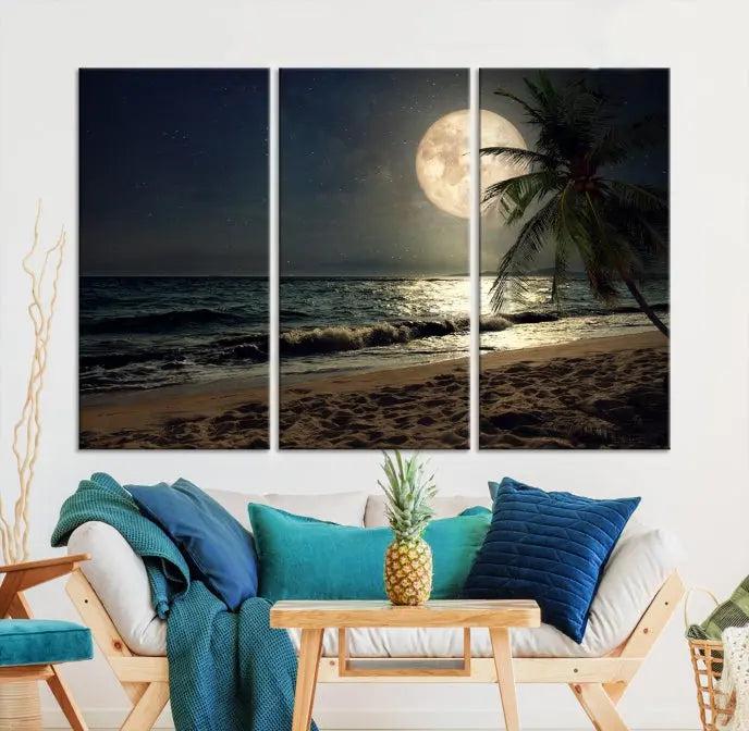 The Tropical Beach and Moon Wall Art Canvas Print features a stunning three-panel artwork of a moonlit beach, complete with waves and a palm tree beneath a starry night sky. It is displayed on museum-quality canvas with an elegant gallery wrap and includes a UV-protective coating for enduring beauty.