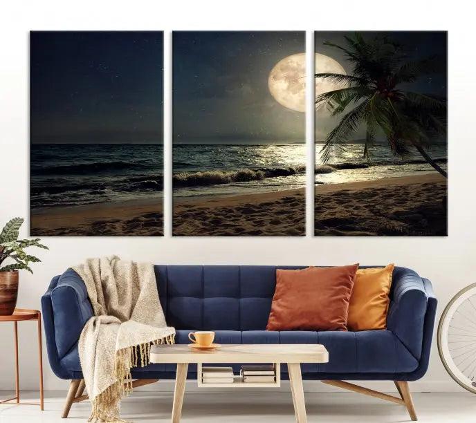 The Tropical Beach and Moon Wall Art Canvas Print features a stunning three-panel artwork of a moonlit beach, complete with waves and a palm tree beneath a starry night sky. It is displayed on museum-quality canvas with an elegant gallery wrap and includes a UV-protective coating for enduring beauty.